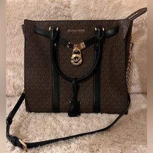 Michael Kors Purse with MK logo and gold detailing. Black and brown leather